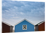 Beach huts in a row against sky by Assaf Frank